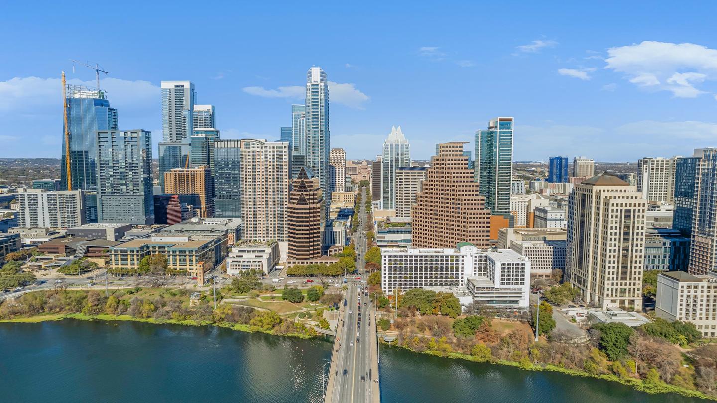 Aerial view of downtown Austin looking along the river toward the Congress Avenue towers