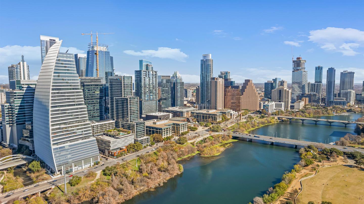 Aerial view of the downtown Austin skyline reflected in Lady Bird Lake on a clear day