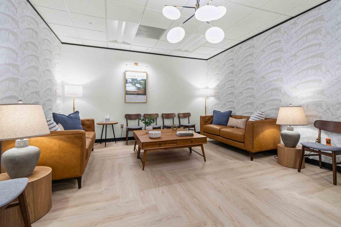 Breakout lounge in an Austin office suite with soft seating against a glazed wall