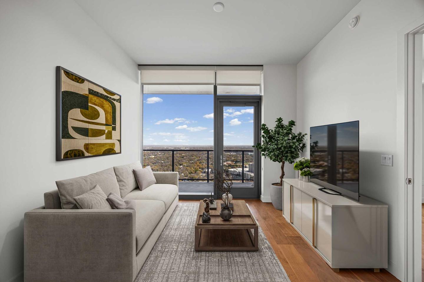 Downtown Austin condo living room with floor to ceiling glass and a view over the city