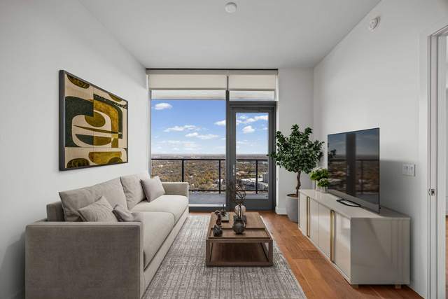 Downtown Austin condo living room with floor to ceiling glass and a view over the city