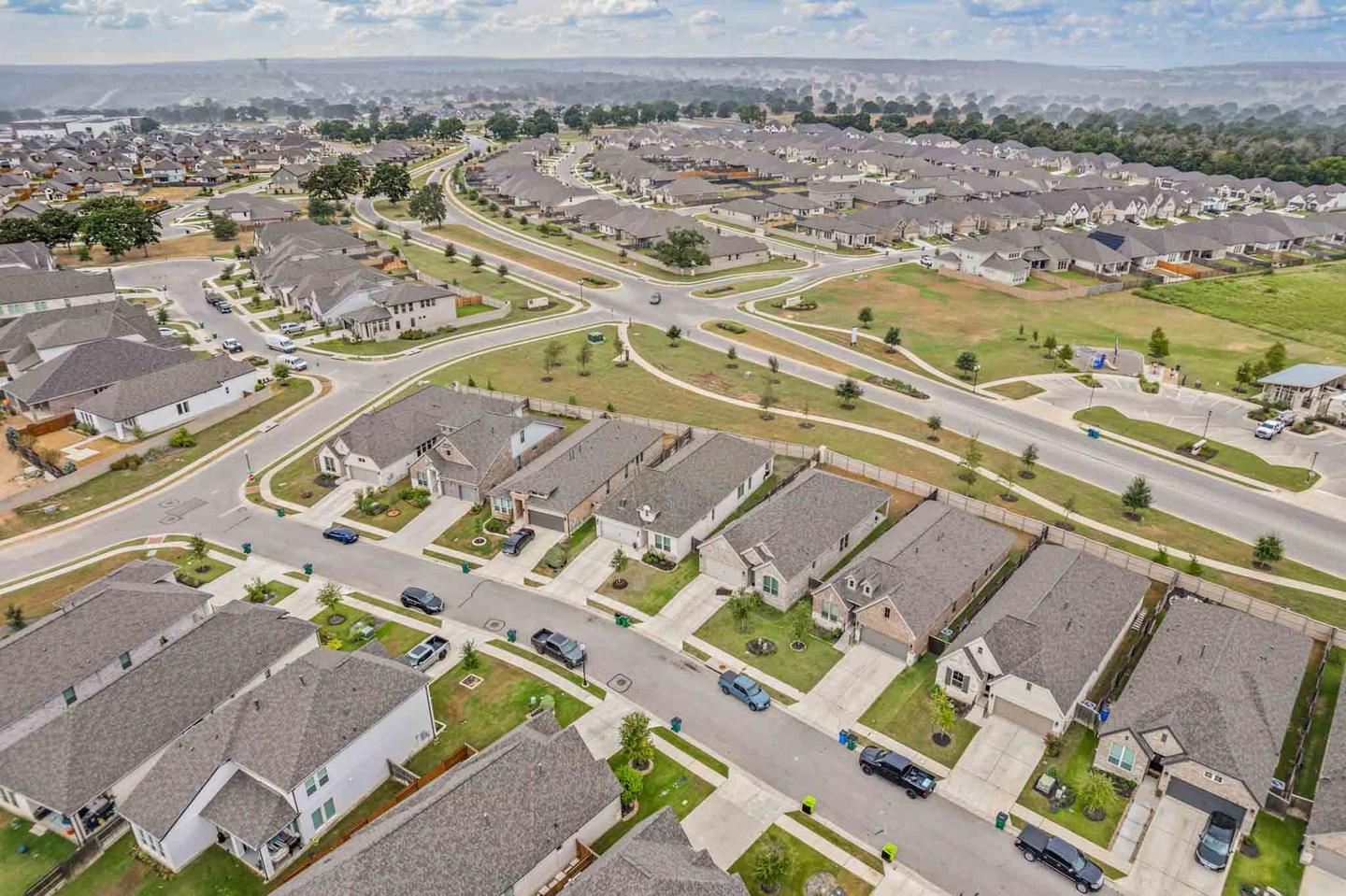 Aerial view of an Austin area subdivision showing street layout and rooftops