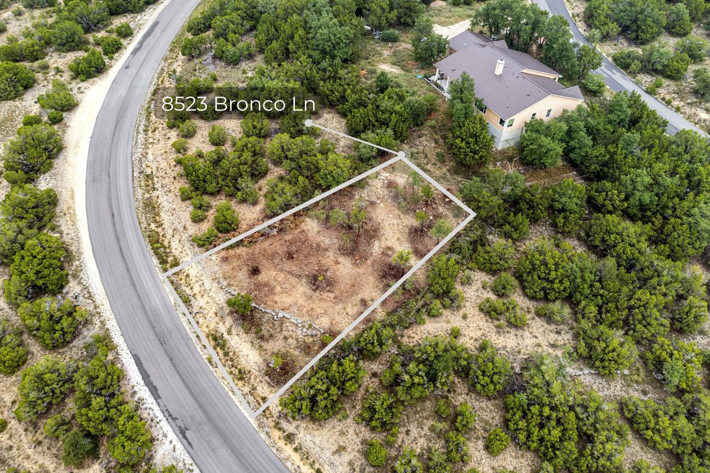 Aerial photograph of a vacant Central Texas parcel with the lot outlined and the road named