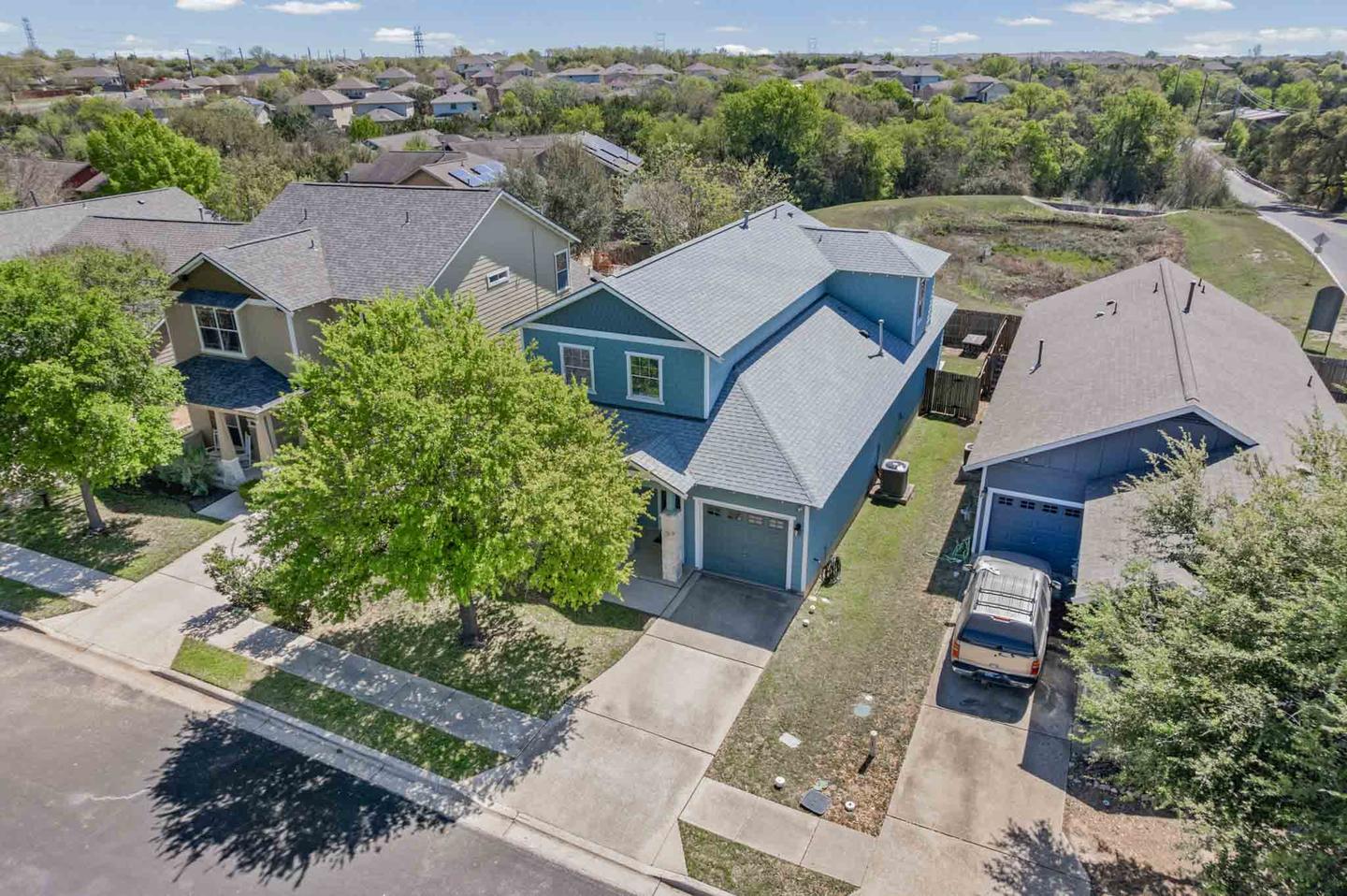 Aerial view of a residential street looking down on a home and its front elevation