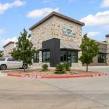 Single story commercial retail building in West Austin with stone and dark cladding