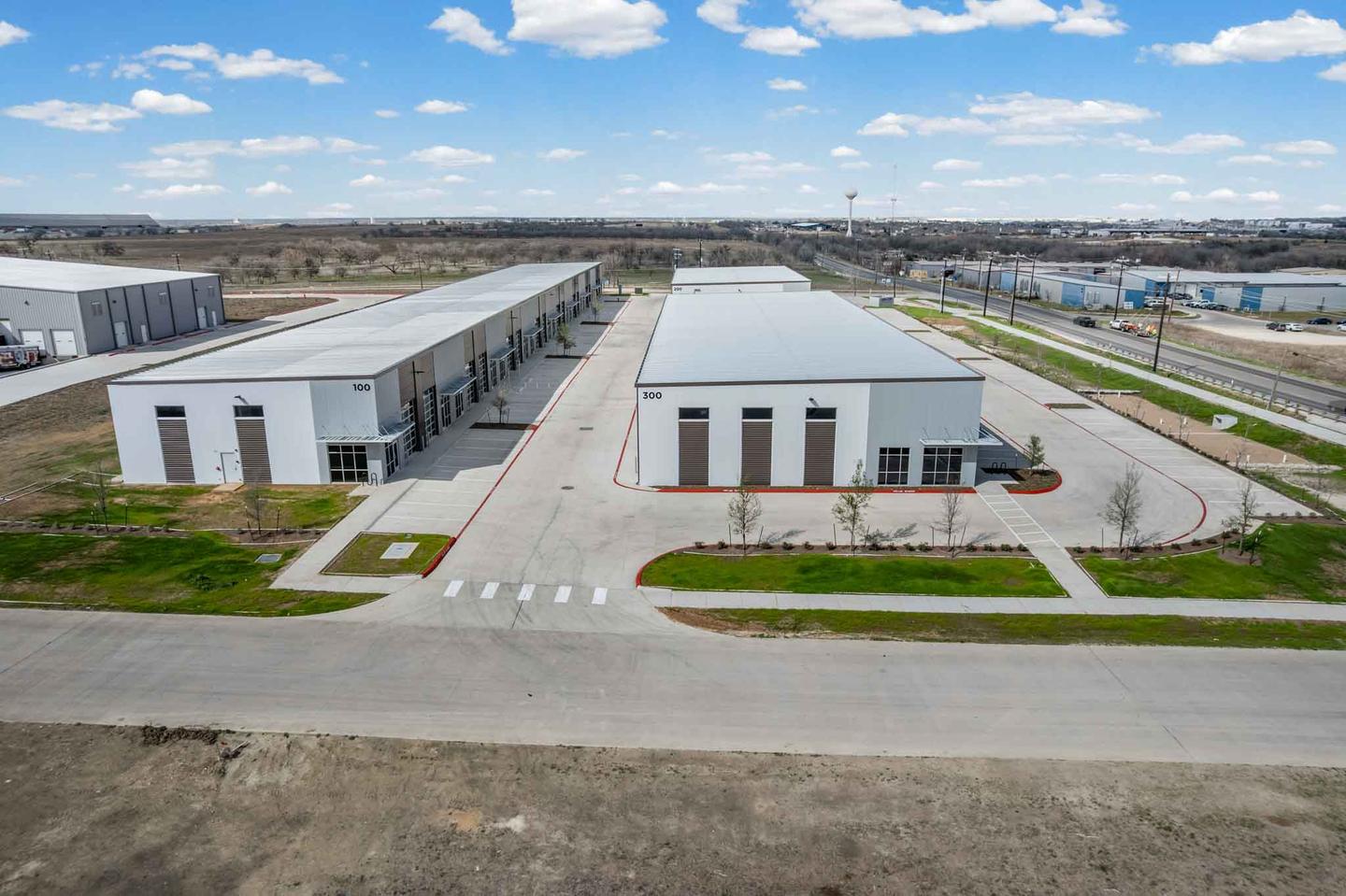 Aerial view of a newly completed warehouse and its parking court in South Austin