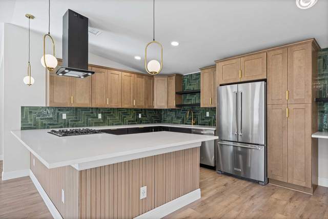 New build kitchen in South Austin with wood cabinetry and a green tile splashback