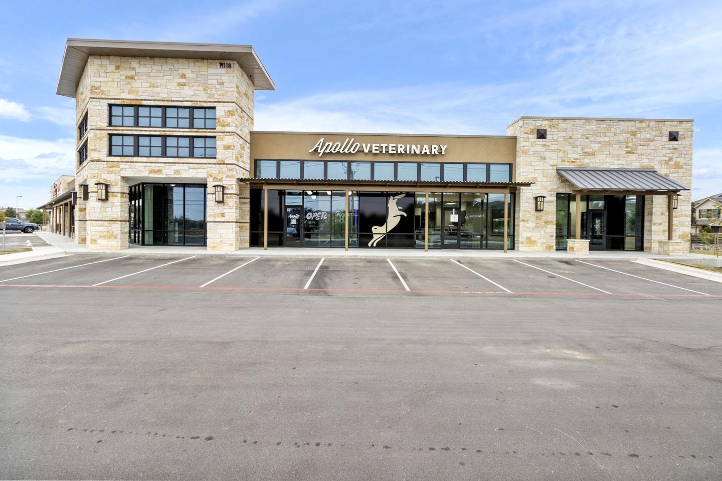 Stone and render veterinary clinic photographed from the parking court with the signage legible