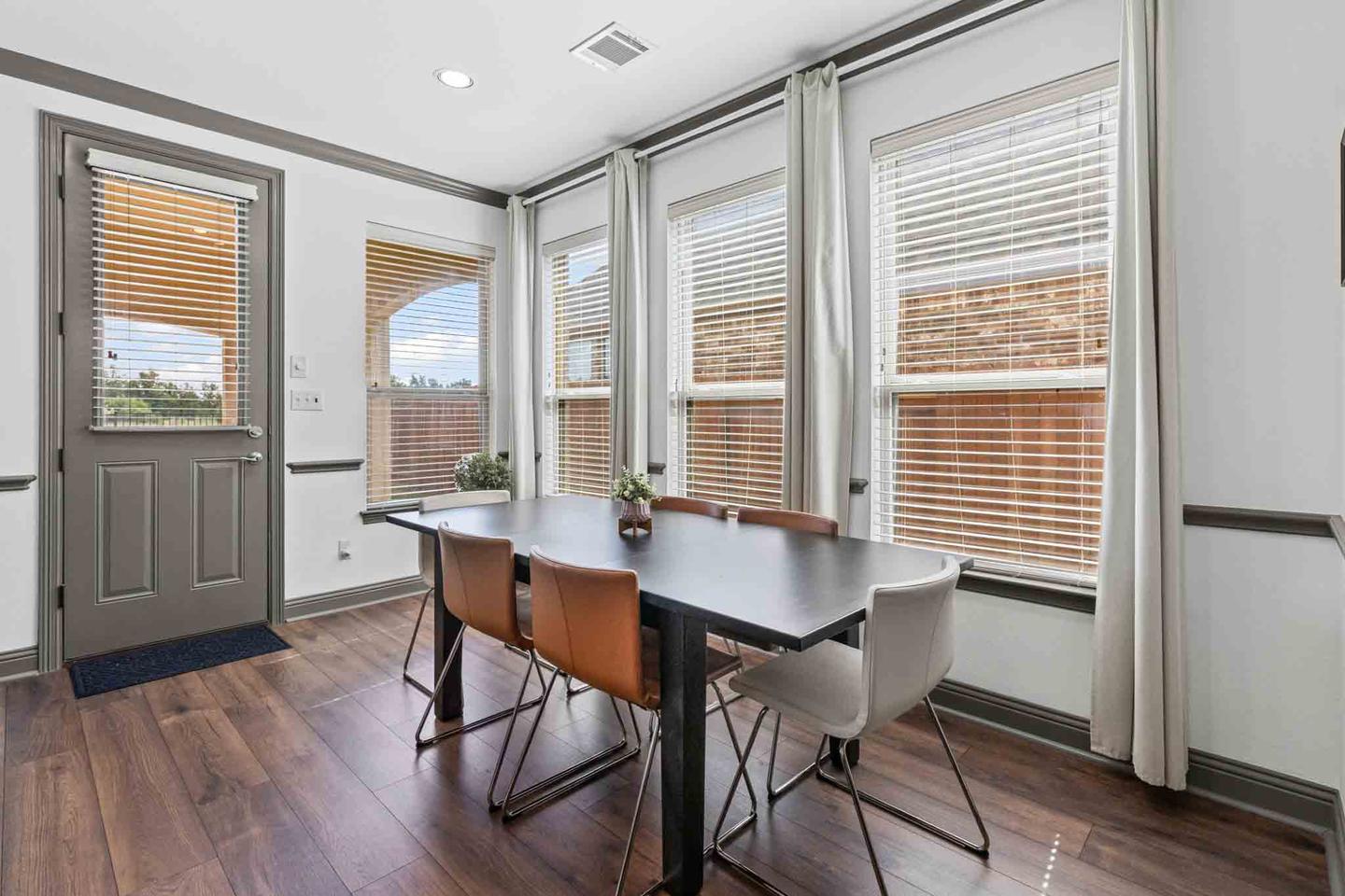 Dining area in Leander open to the kitchen with bar stools at the island