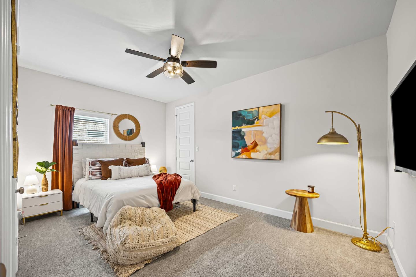 Guest bedroom in a Bastrop home with soft natural light and a neutral palette