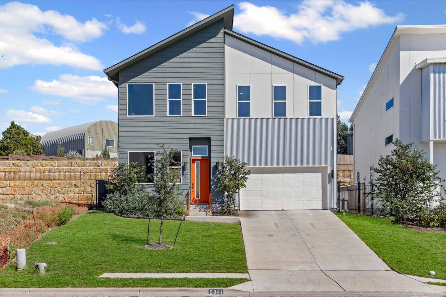Modern gray and white two story home in East Austin photographed from the front