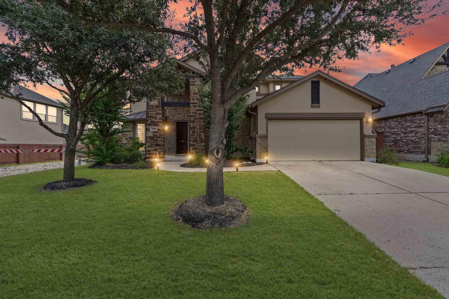 Single story home in Leander photographed from the driveway in warm evening light