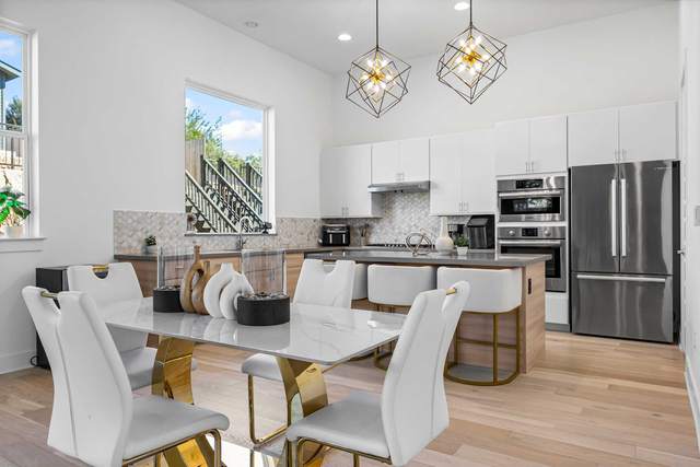 Open kitchen and dining space in a Westlake home with a stone island and full height glazing