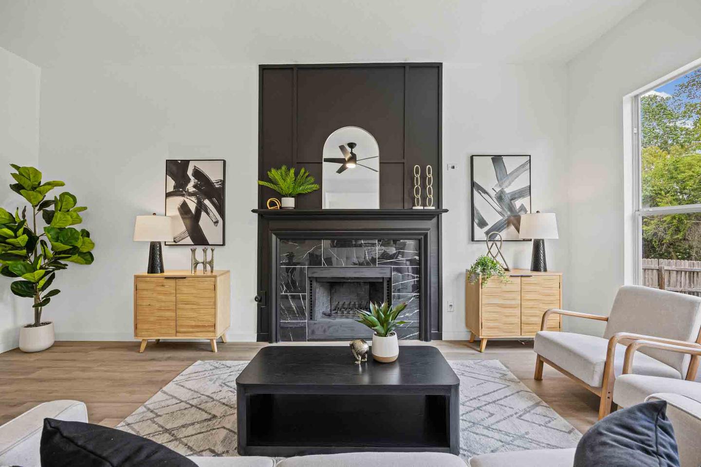 Living room photographed wide enough to read the fireplace, the shelving and the seating without stretching the walls