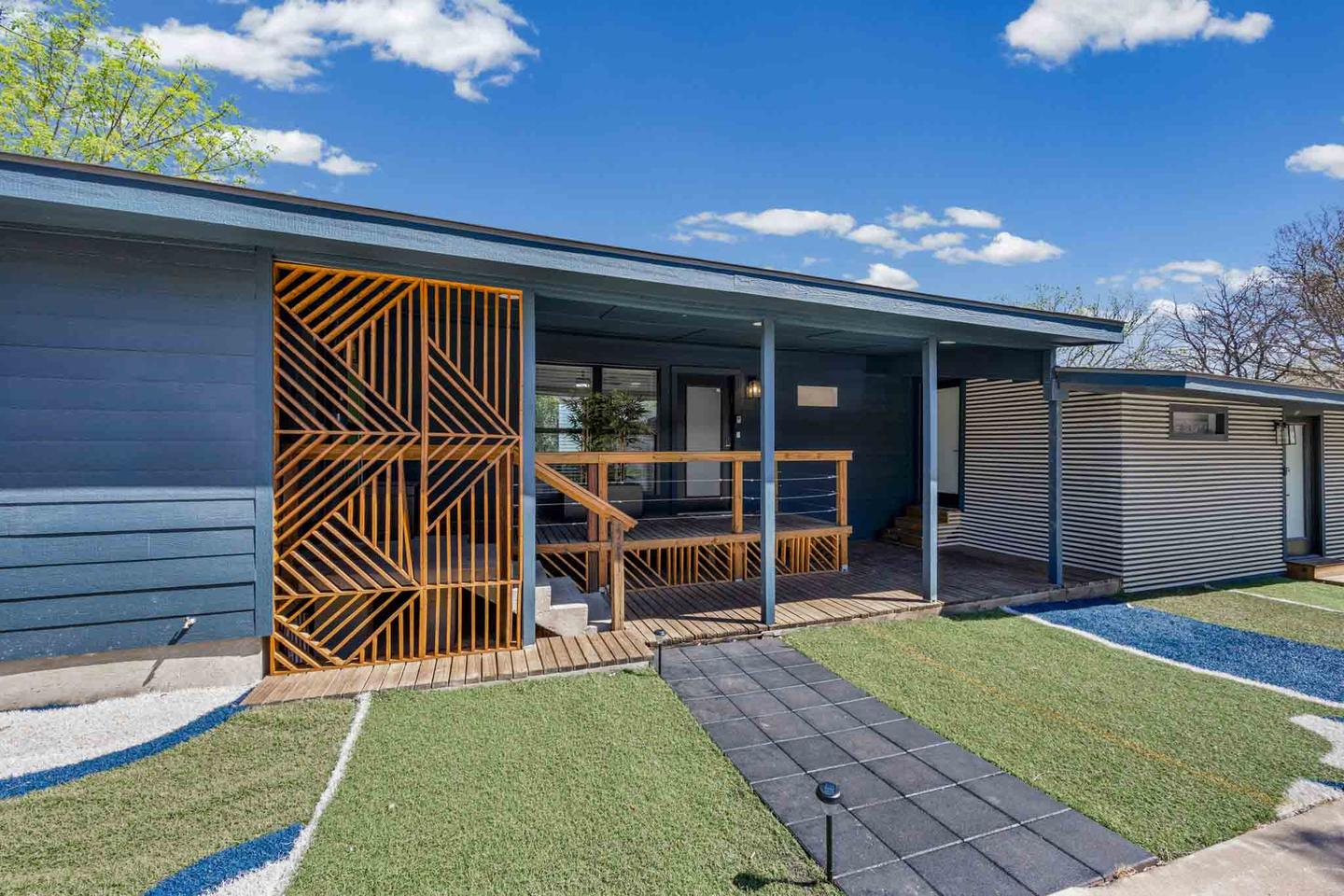 Front elevation of a mid century modern home in Austin, photographed straight on from the curb