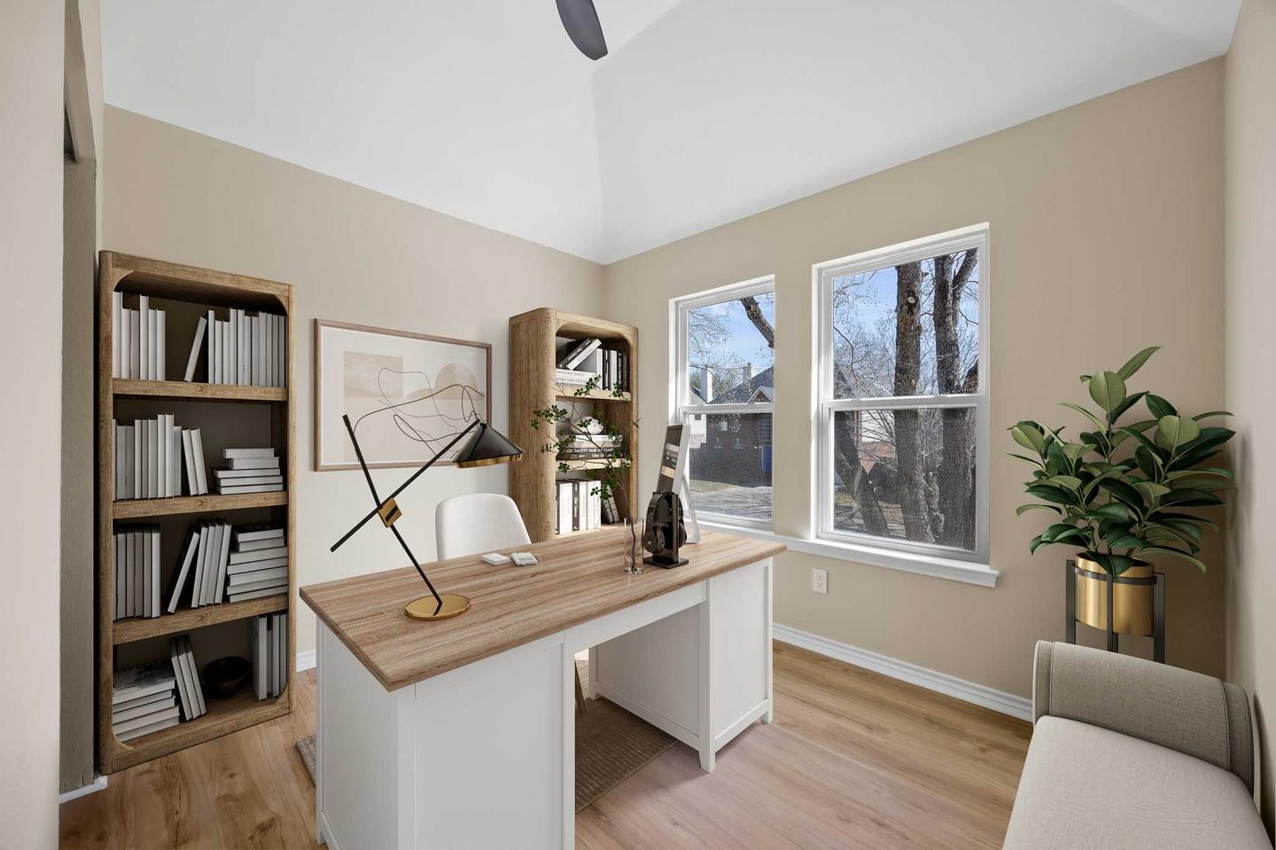 Spare room digitally staged as a study with a writing desk, open shelving and a potted plant