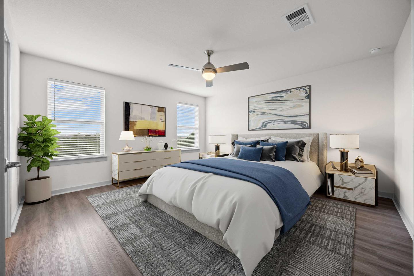 The same Pflugerville bedroom staged with a low bed, timber side tables and framed art