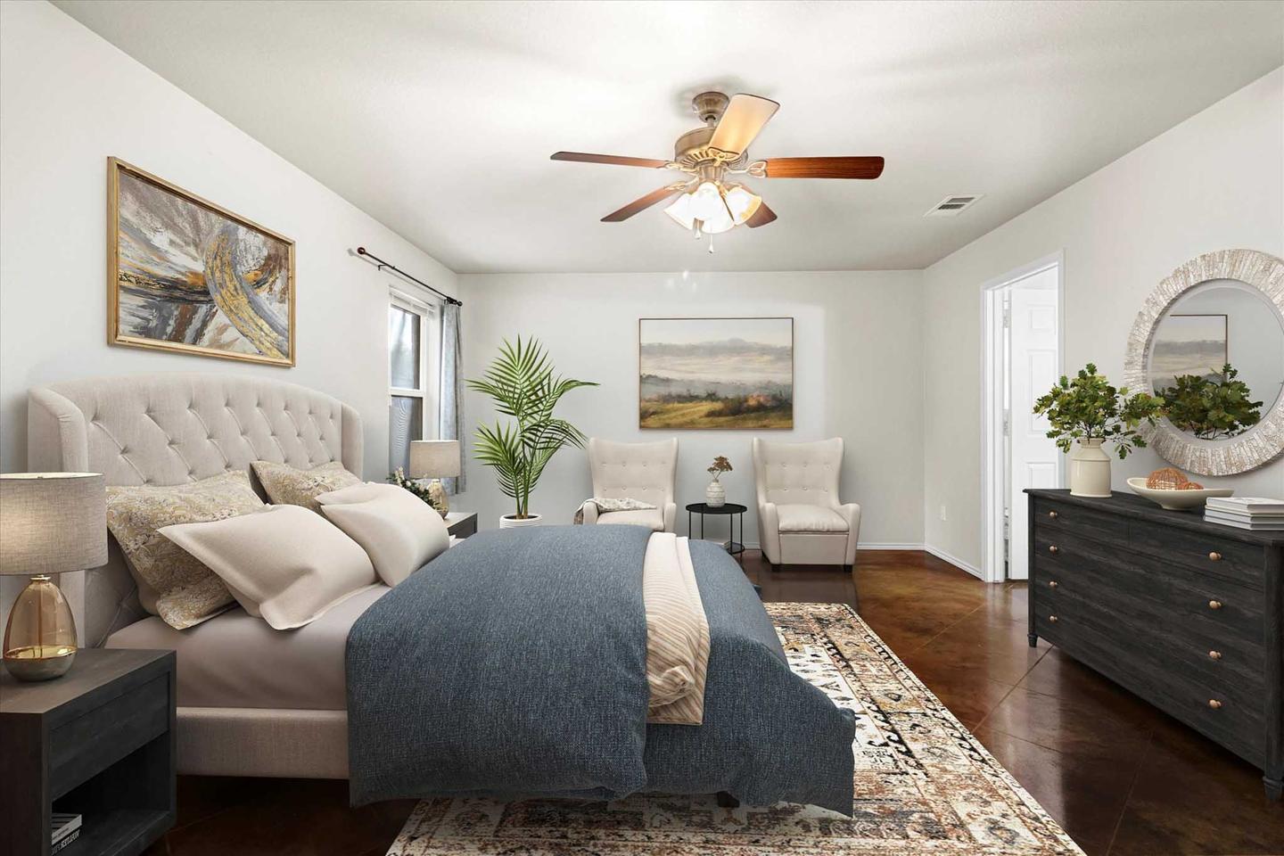South Austin bedroom staged with a made bed, side tables and framed art