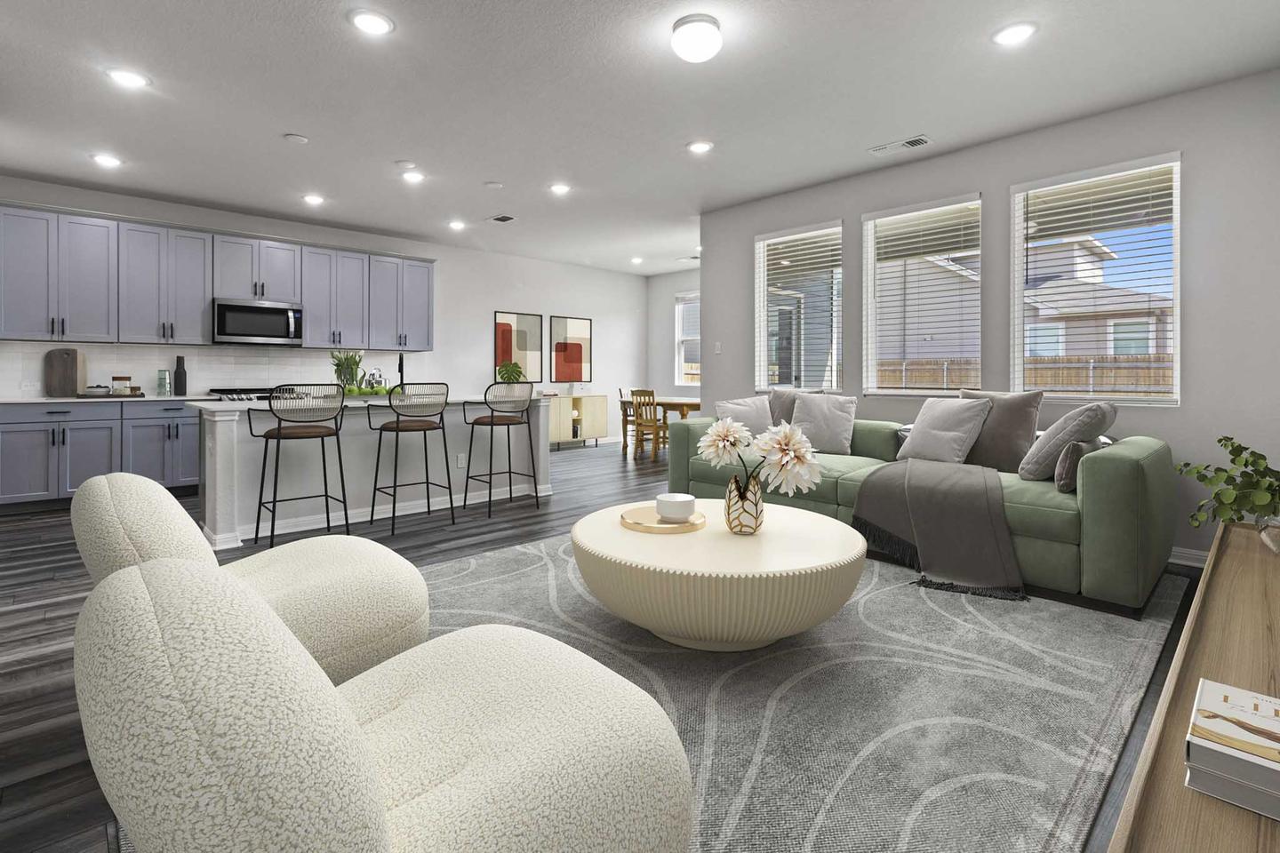 Open plan living room digitally furnished with a curved sofa, two armchairs and a round coffee table